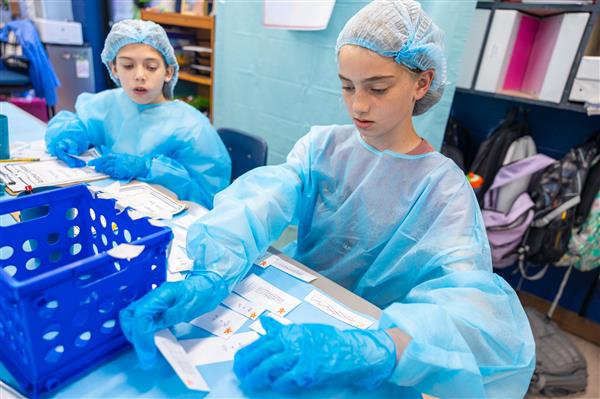 students in scrubs working at tables